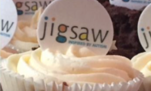 Birthday cup cake with Jigsaw logo on top