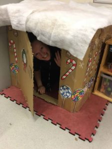 supervisor hiding in gingerbread house in class