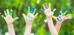 iStock image children painted hands in air